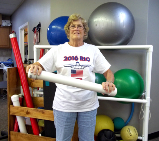 Woman using water filled tube for balance and core strengthening