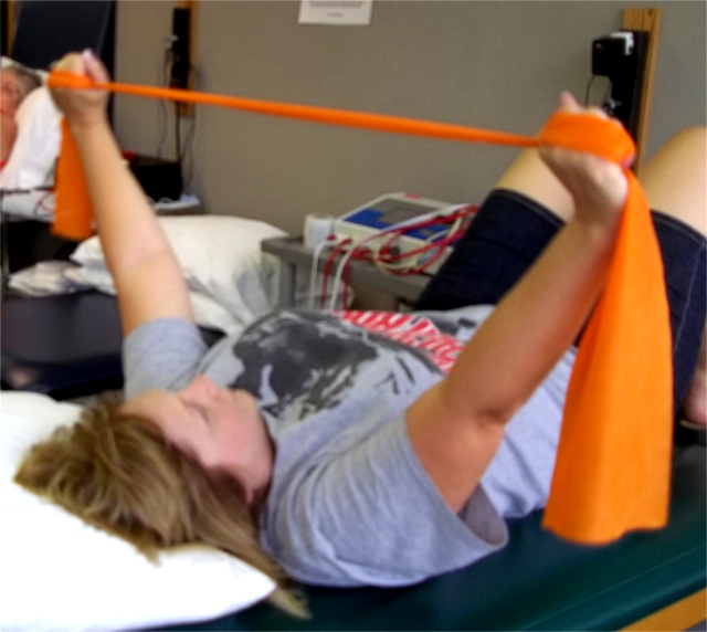 Patient using Theraband for shoulder